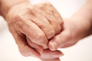 Young and old hands together