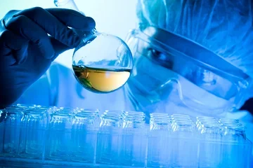 Scientist look at tube filled with liquid