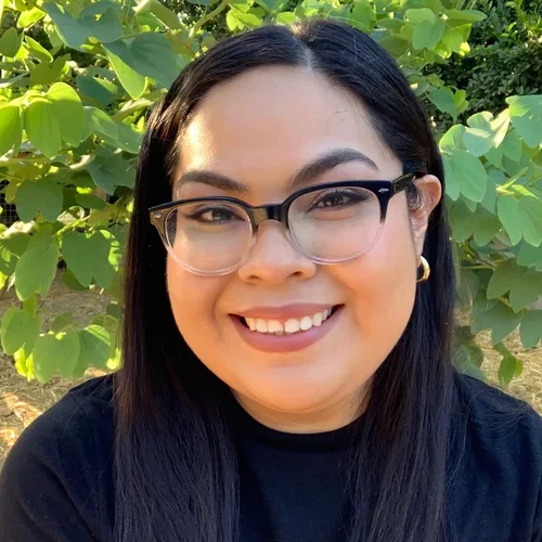 Karina Munos, female, smiling for professional portrait.