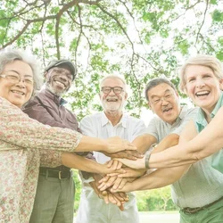 diversity group of male and female, stack hands in the center supporting active lifestyle