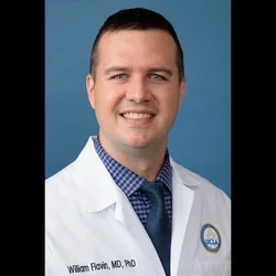 Dr. William Flavin - neurologist in white coat