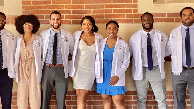Members of the Student National Medical Association in short white coats